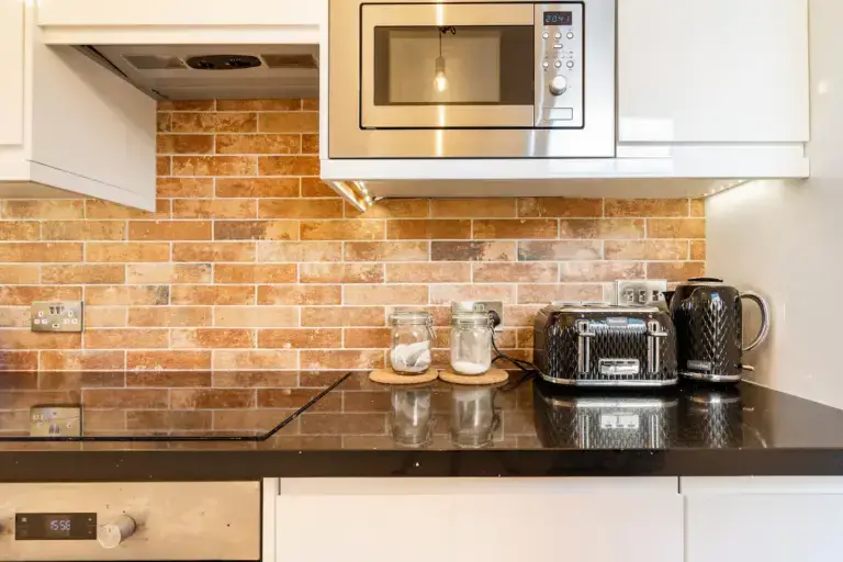 Kitchen worktop with a microwave, coffee machine and toaster