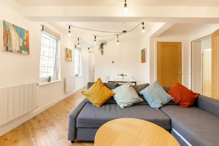 Grey corner sofa with colourful cushions in an apartment lounge
