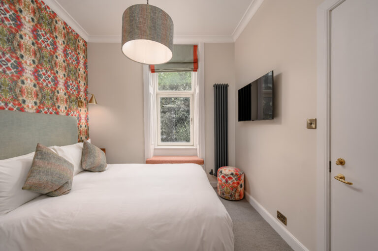 Guest bedroom with a double bed and white wardrobe