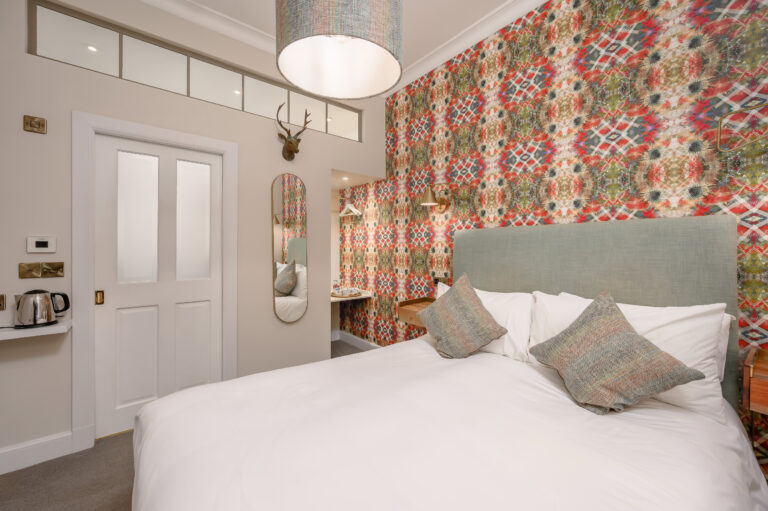 Double bedroom beside an open en-suite bathroom door