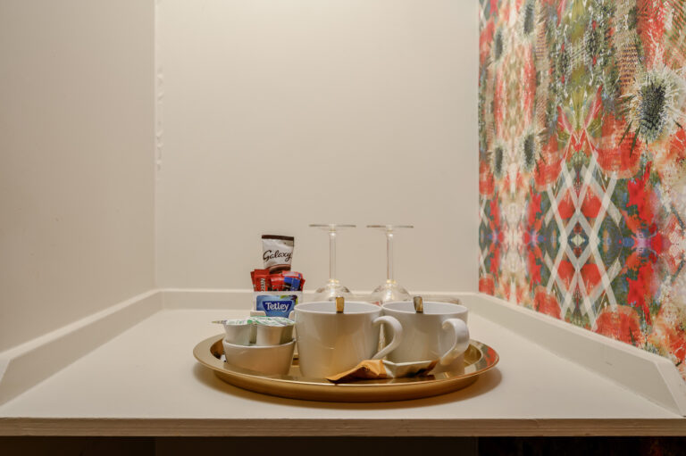 Guest room tea tray with cups and a cafetiere