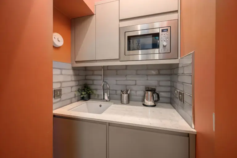 Studio kitchenette with a microwave and kettle