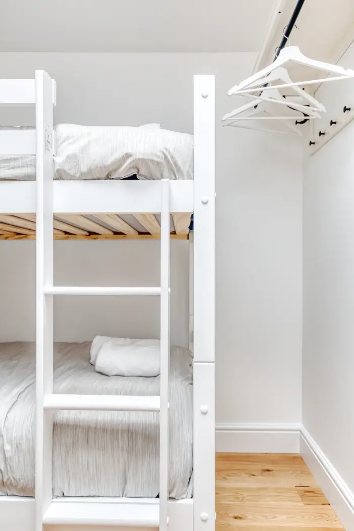 White bunk beds with individual reading lights
