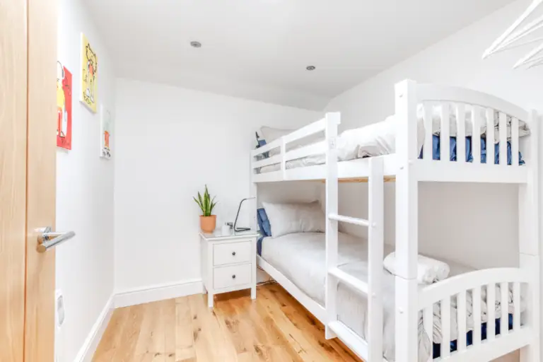 White bunk beds in a bright apartment bedroom