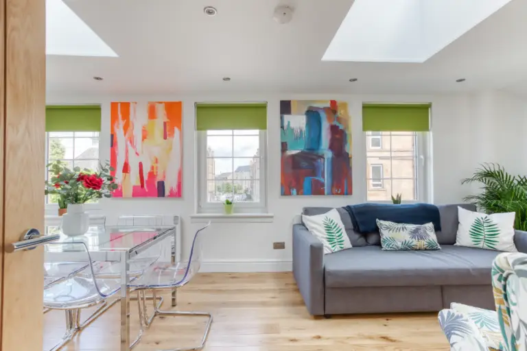 Open-plan dining and living area with colourful artwork