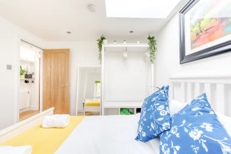 Double bedroom with wooden flooring and a skylight