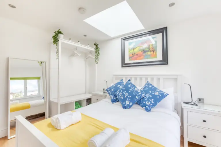 Double bedroom with a skylight and yellow bed runner